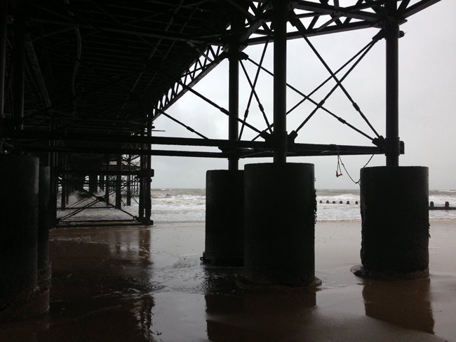 Sheltering under Cromer pier